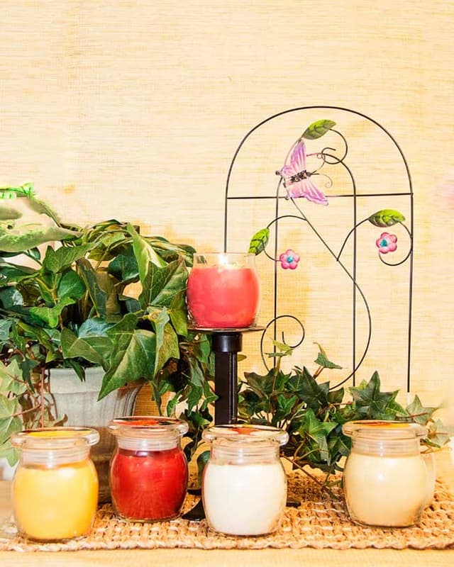 Jar candles with ivy and a garden trellis