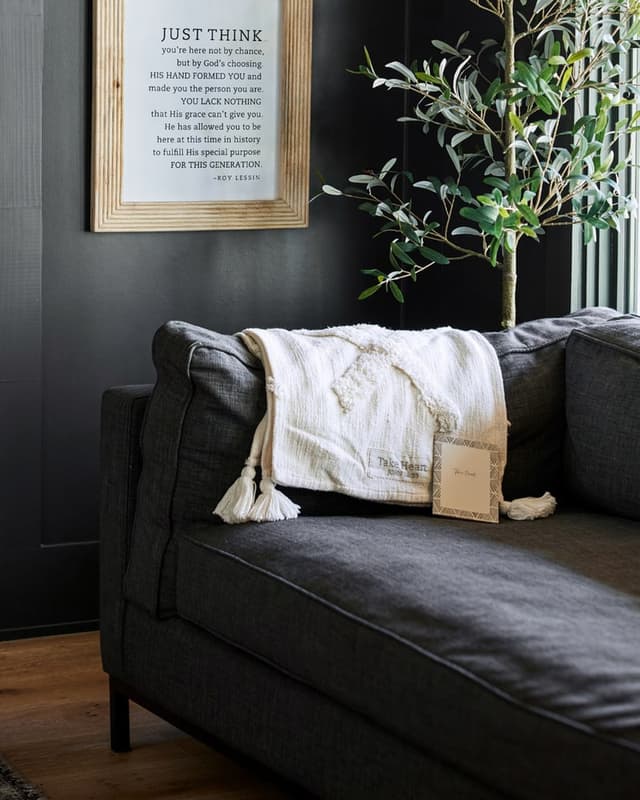 Framed verse print and throw in a living room setting