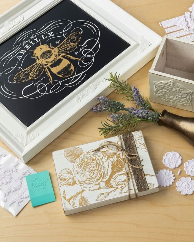 Gold bee design on a framed chalkboard