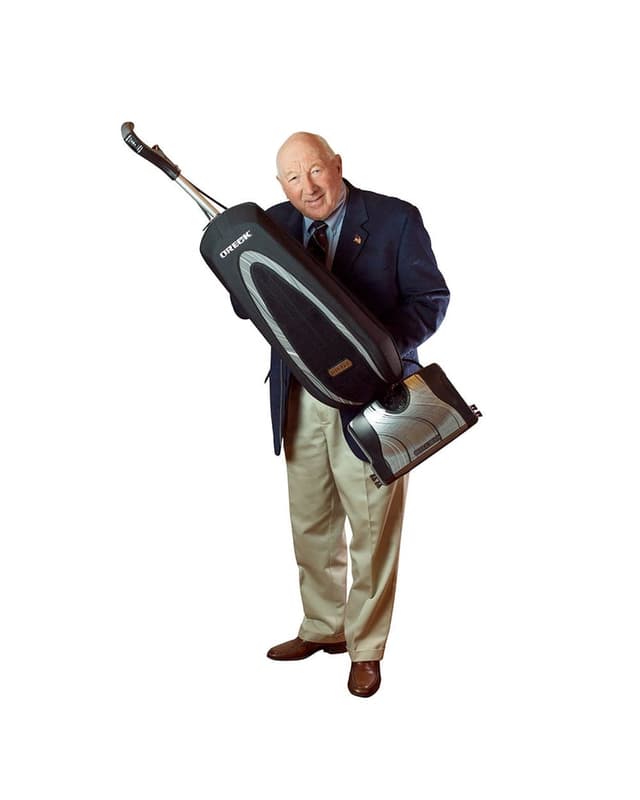 David Oreck with an Oreck vacuum, as shown on the candle company's About page