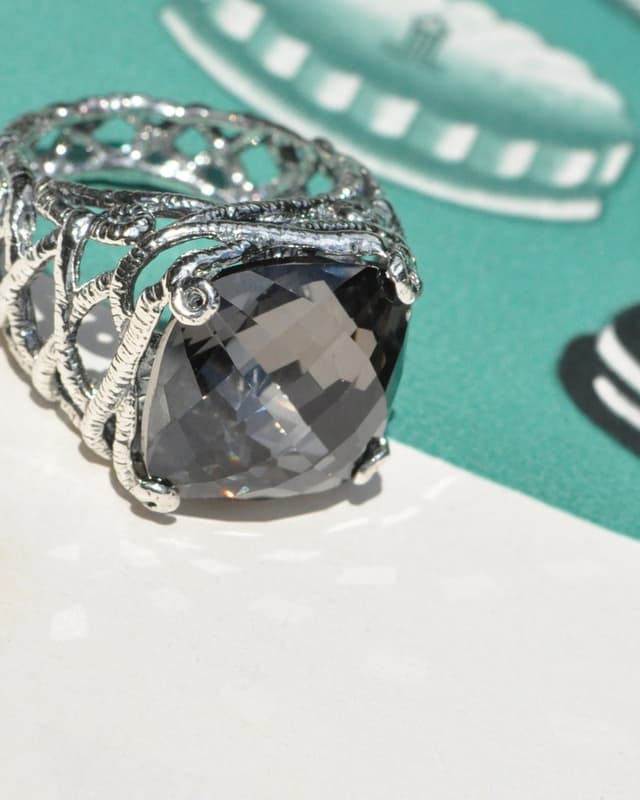 Silver filigree cocktail ring with a smoky faceted stone