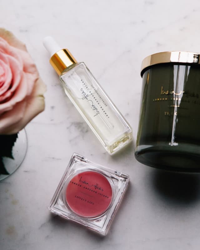 Beauty oil, lip color and scented candle
