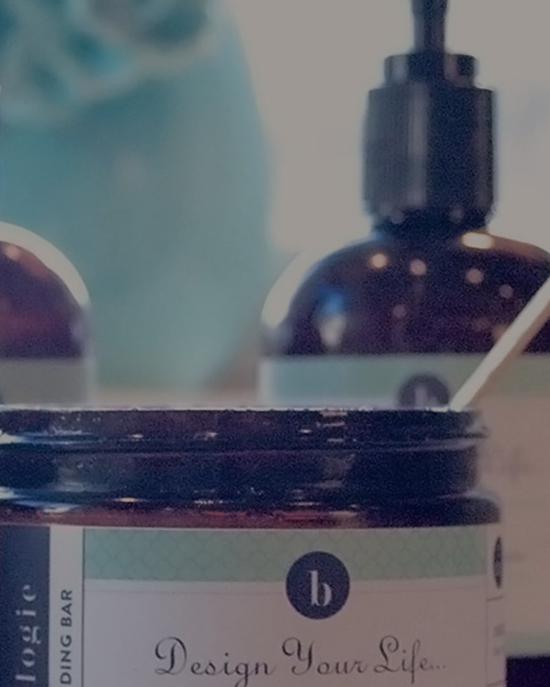 Amber jars and pump bottles with Design Your Life labels