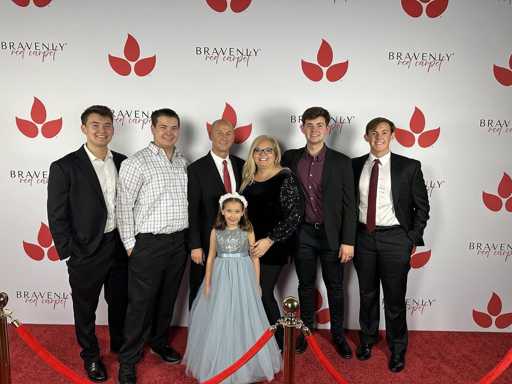 Aspen and Brent Emry with their five children on the red carpet at a Bravenly event