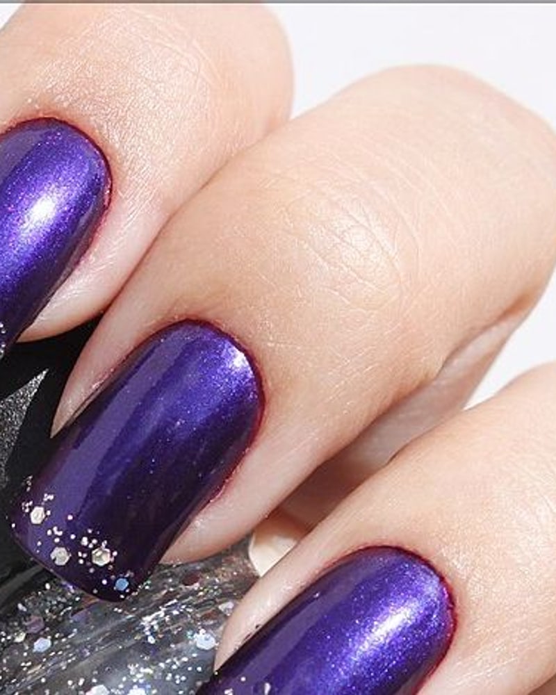 Glitter-tipped manicure, as with the nail foils Cloud 9 sold (illustrative)