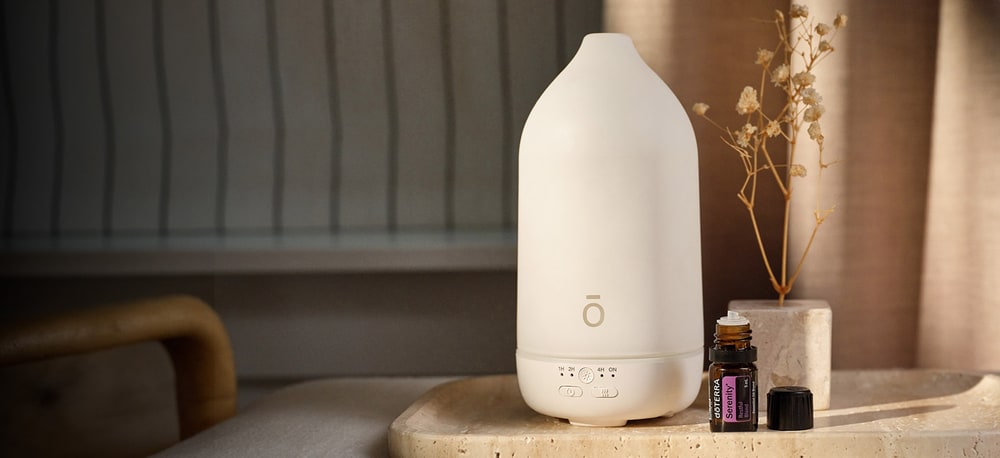 doTERRA ceramic diffuser on a stone tray beside a bottle of Serenity Restful Blend