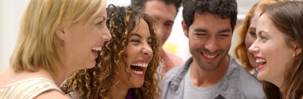 A group of friends laughing together at a gathering
