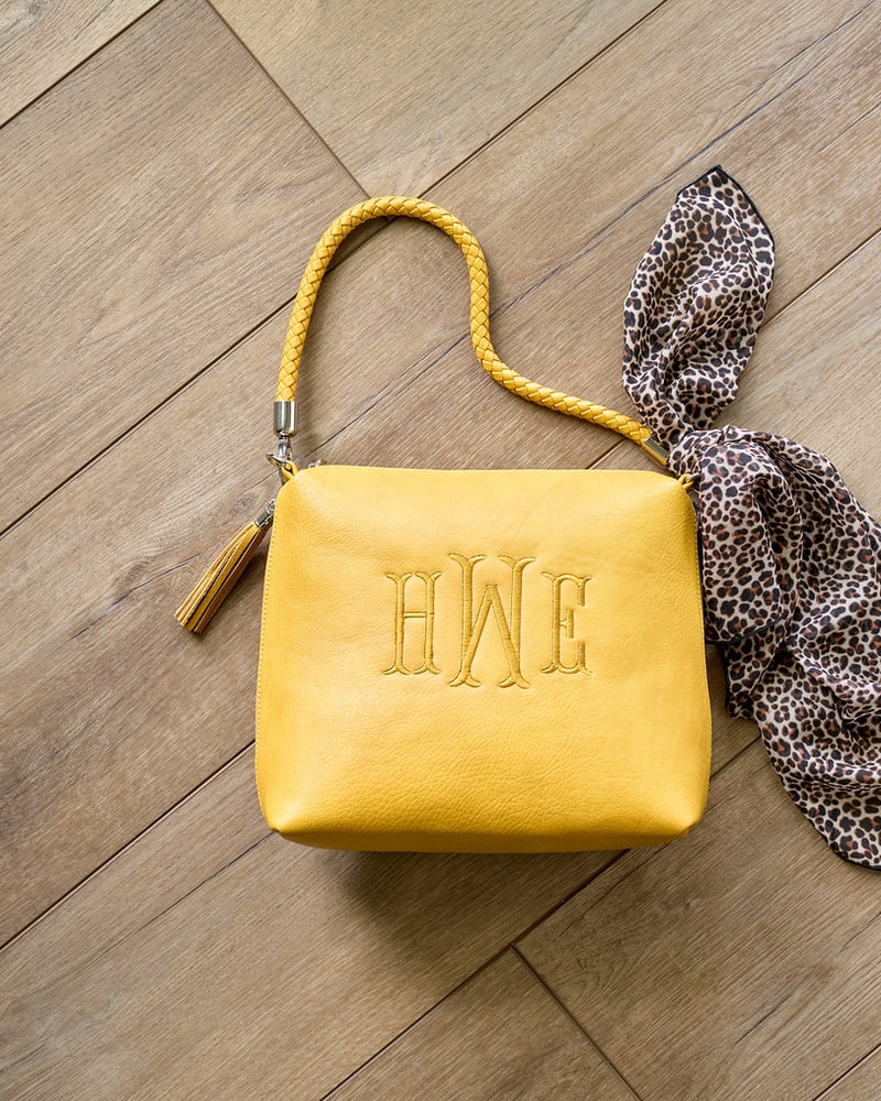 Monogrammed mustard shoulder bag with a leopard scarf