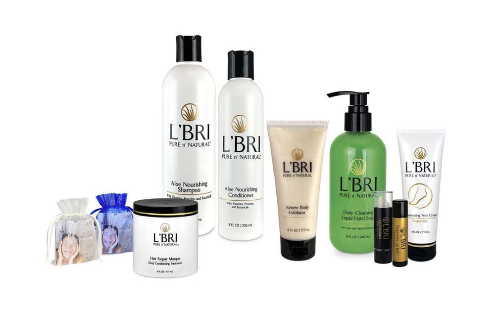 L'BRI shampoo, conditioner, hair masque, body exfoliator, hand soap, lip balms and foot cream on a white background