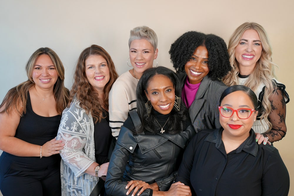 A group of eight smiling LimeLife Beauty Guides posing together