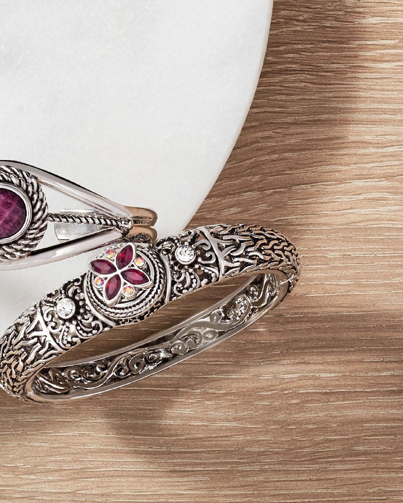 Silver-tone snap bangles with a purple flower Snap