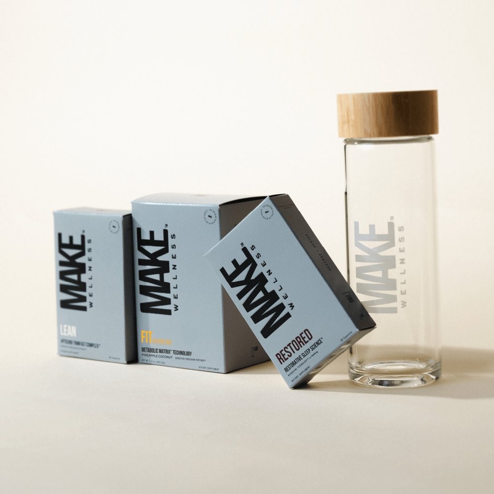 LEAN, FIT and RESTORED boxes beside a glass MAKE Wellness water bottle