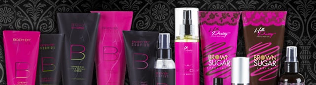 A row of pink and black Passion Parties lotion tubes, body sprays and massage creams