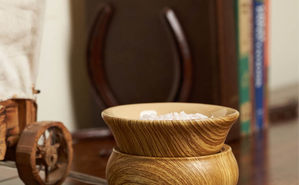 Pink Zebra Wood Grain Simmer Pot filled with Sprinkles wax melts on a wooden table