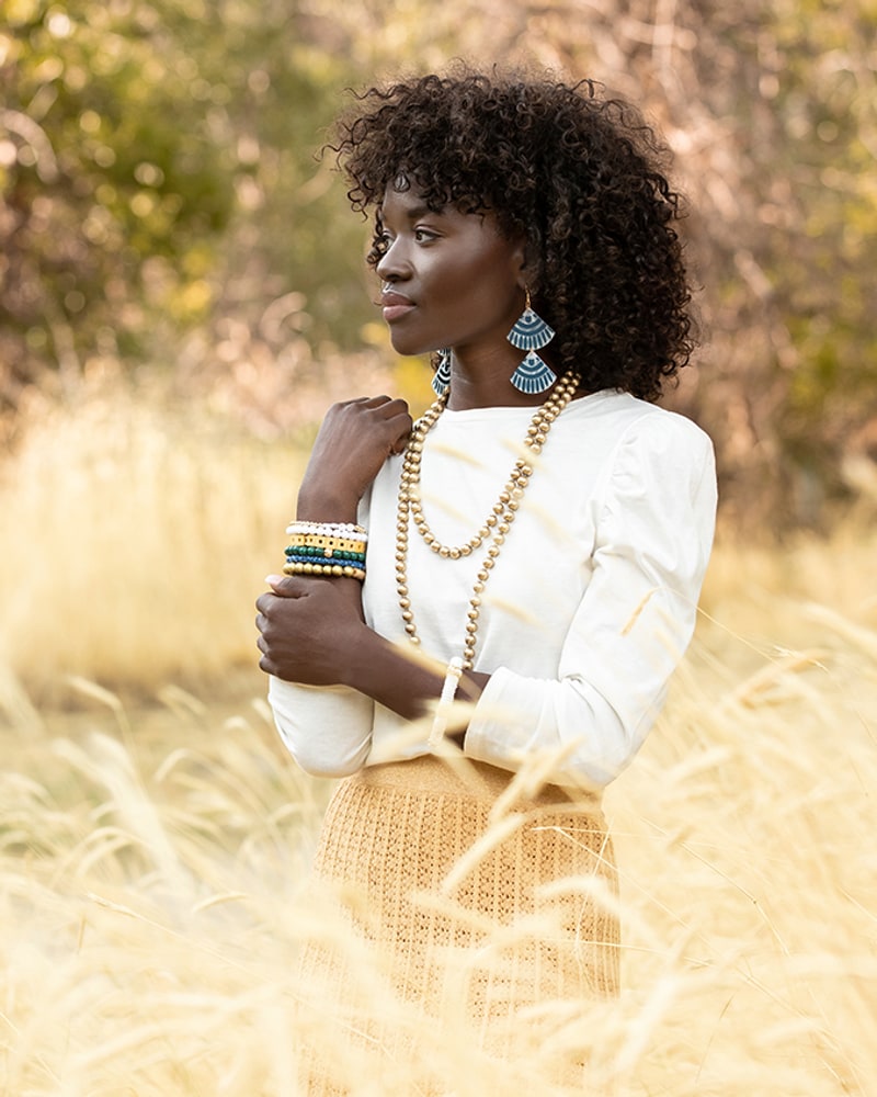 Layered gold necklaces, beaded bracelets and statement earrings