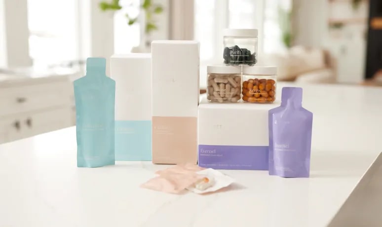 THREE supplements including Collagène, Vitalité, Purifí, Imúne, Revíve and Éternel on a kitchen counter