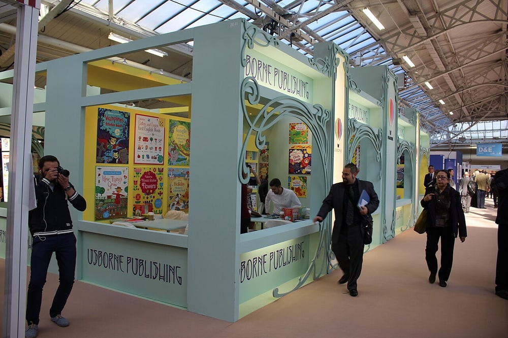 The Usborne Publishing stand at the London Book Fair, with large sticker and activity book covers on display