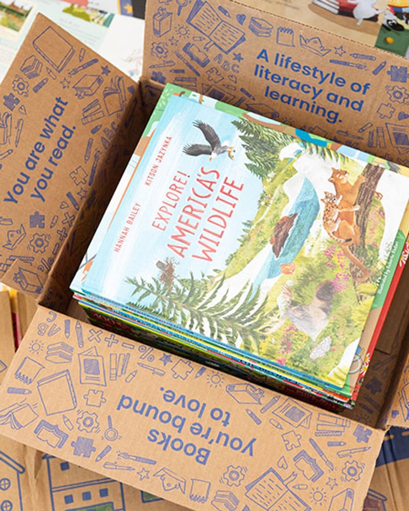 A box of picture books, including Explore! America's Wildlife